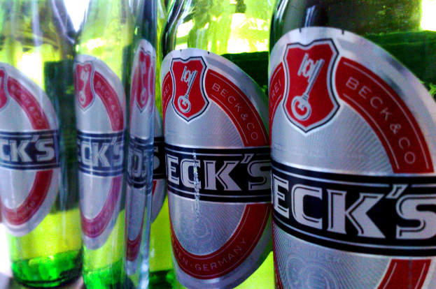 Ein grünes Bierflasche mit einem daran befestigten Etikett.