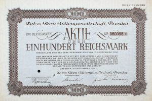 Ein altes deutsches Aktienzertifikat mit schwarzem Rand und der Aufschrift "Aktie über Einhundert Reichmark".