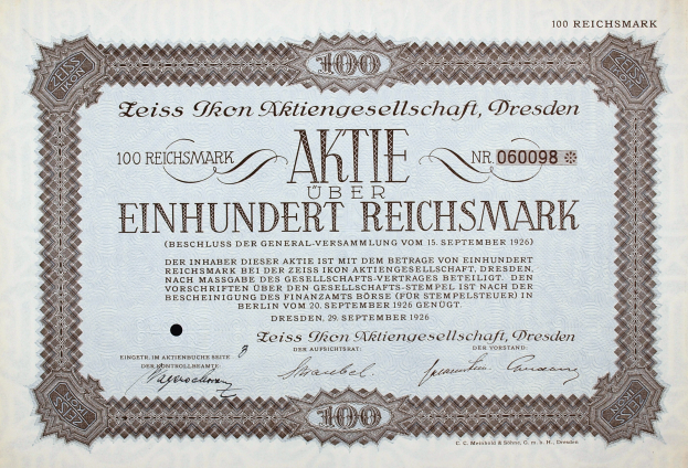 Ein altes deutsches Aktienzertifikat mit schwarzem Rand und der Aufschrift "Aktie über Einhundert Reichmark".