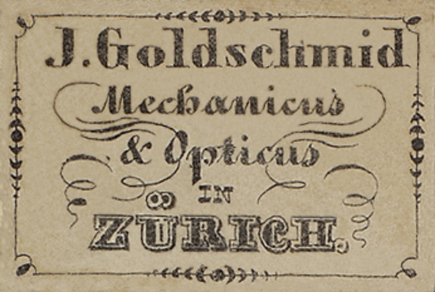 Eine alte Visitenkarte mit der Aufschrift "J. Goldschmidt Mechanicus & Optik in Zürich" aus dem frühen 20. Jahrhundert.
