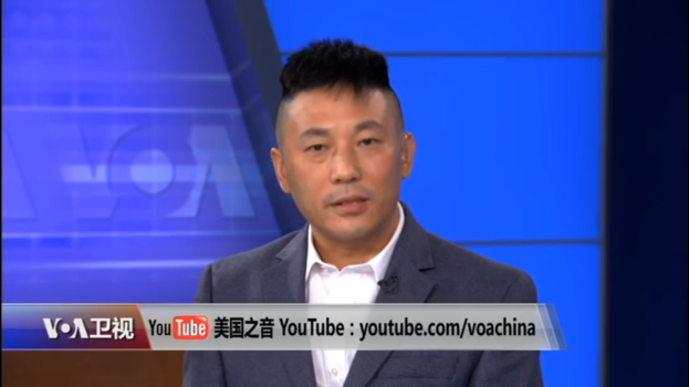 Ein chinesischer Nachrichtensprecher in Anzug und Krawatte, der auf einem TV-Bildschirm spricht, mit Text unten auf einem blauen Hintergrund.