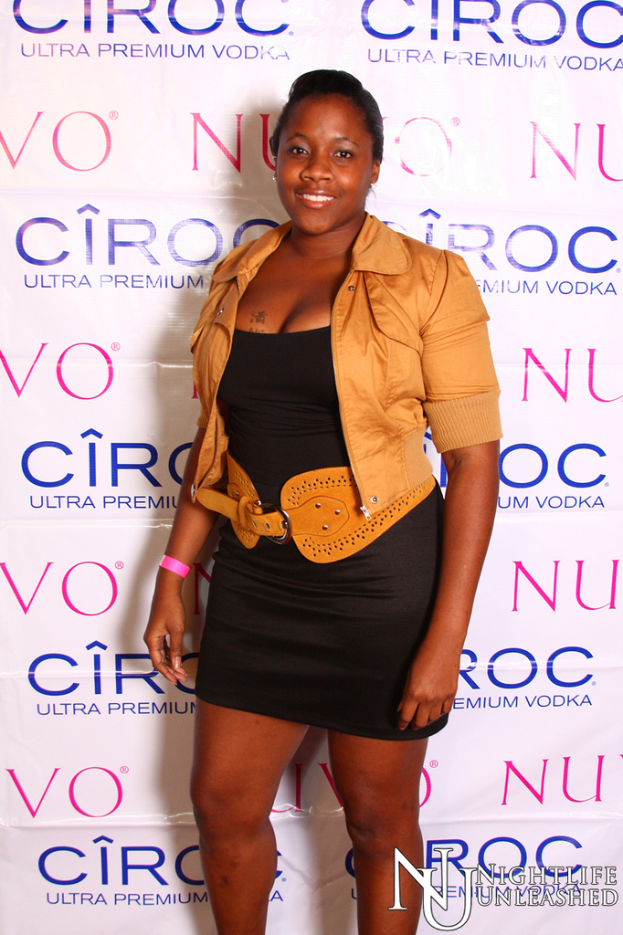 Eine Frau lächelt vor einer Wand mit einem Sponsorennamen.